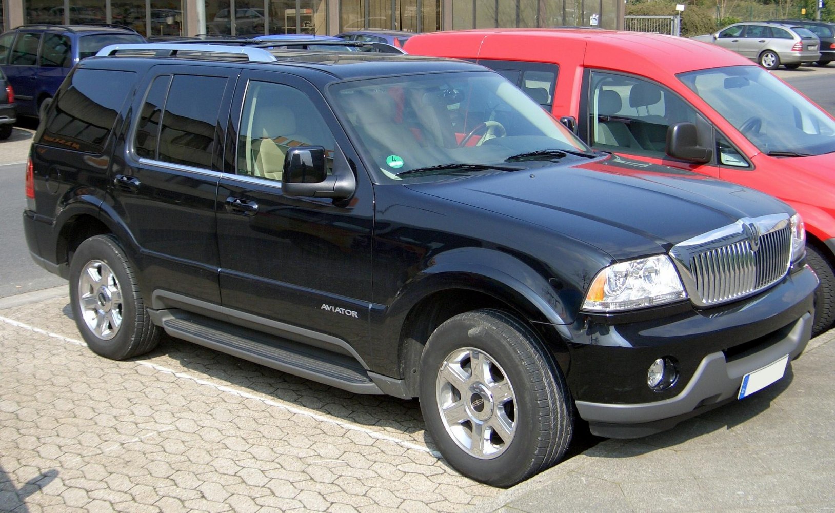 Black SUV front side view with chrome grille and running boards