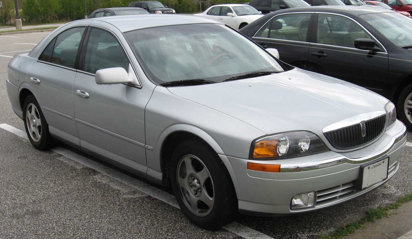Silver sedan front-side profile with classic aerodynamic design and distinctive headlights
