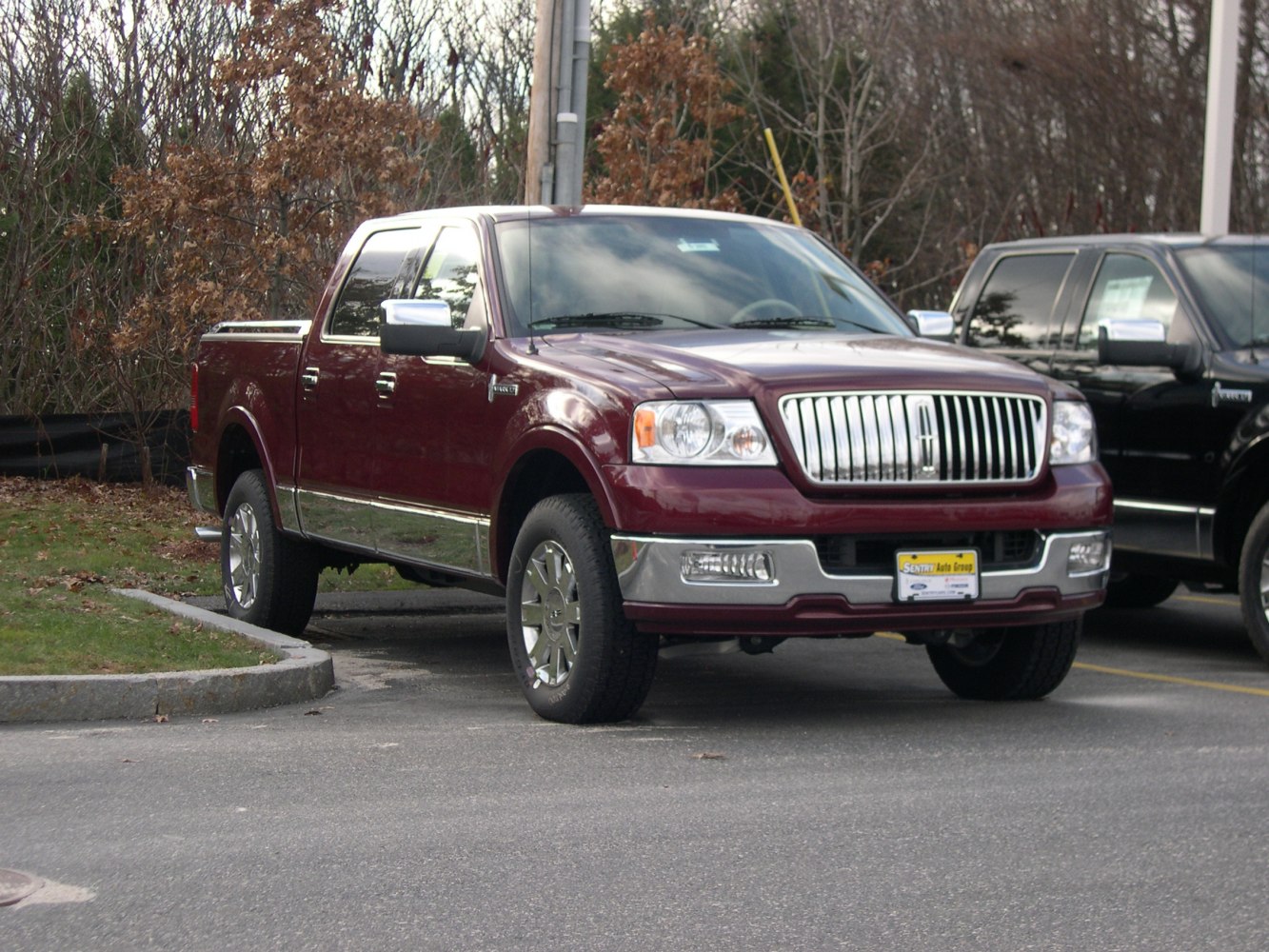 Luxury pickup with vertical grille bars and chrome trim