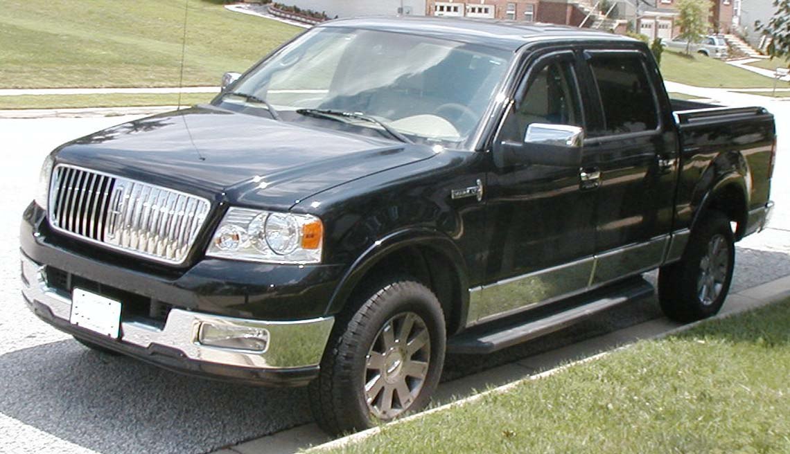 Pickup truck with chrome grille, dual cab, and running boards