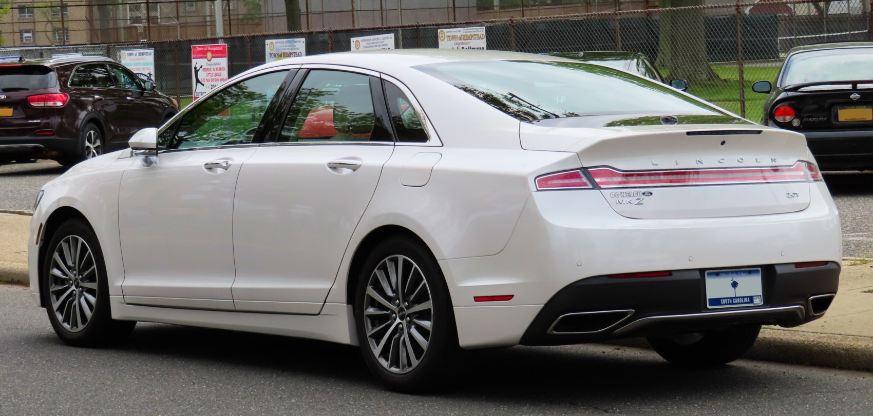 Rear and side profile showing aerodynamic sedan silhouette and taillight design