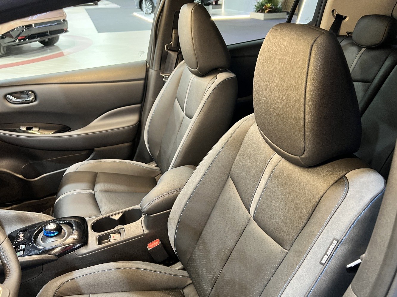 Modern front seats with center console and gear selector