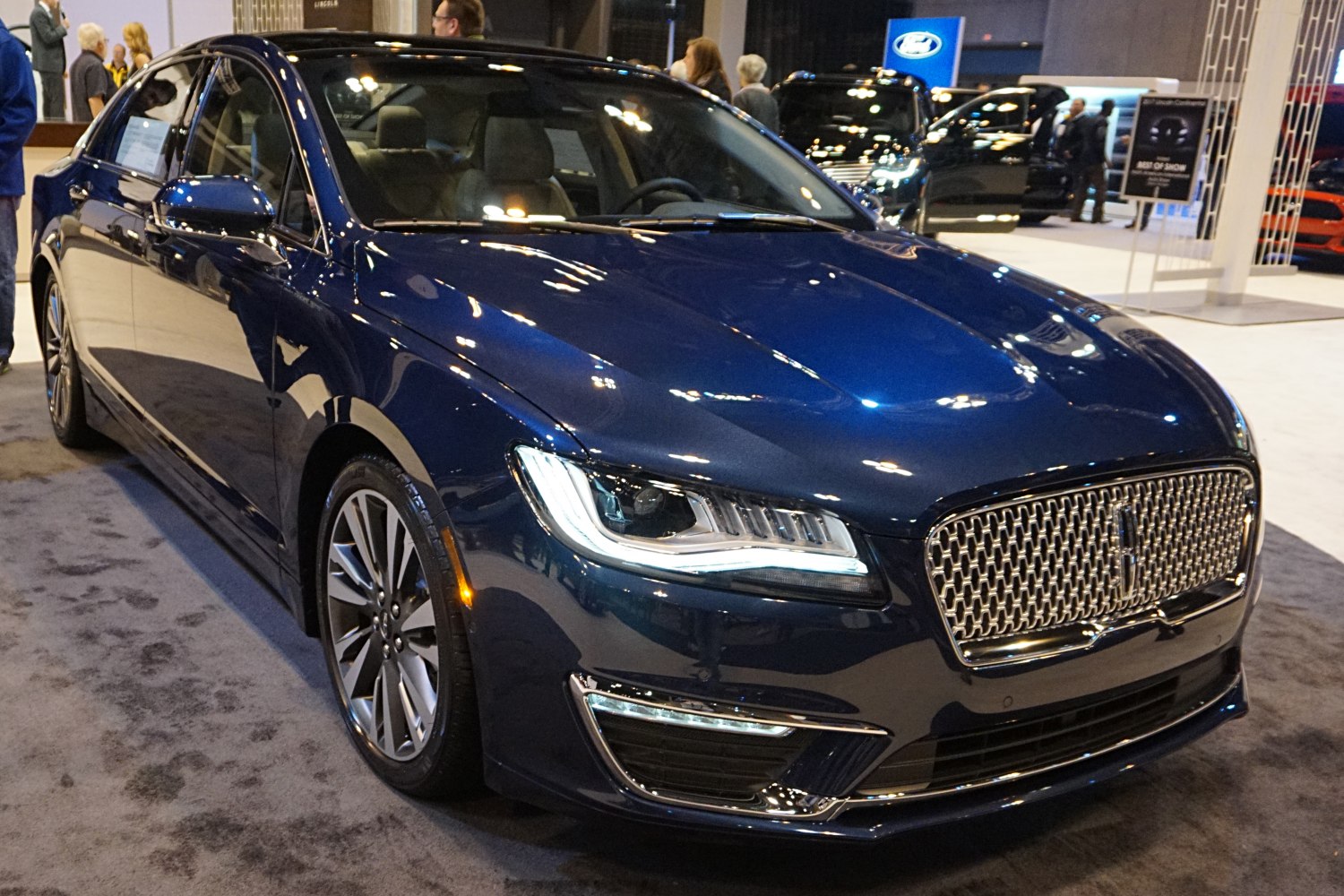 Luxury sedan front fascia with LED headlights and chrome mesh grille