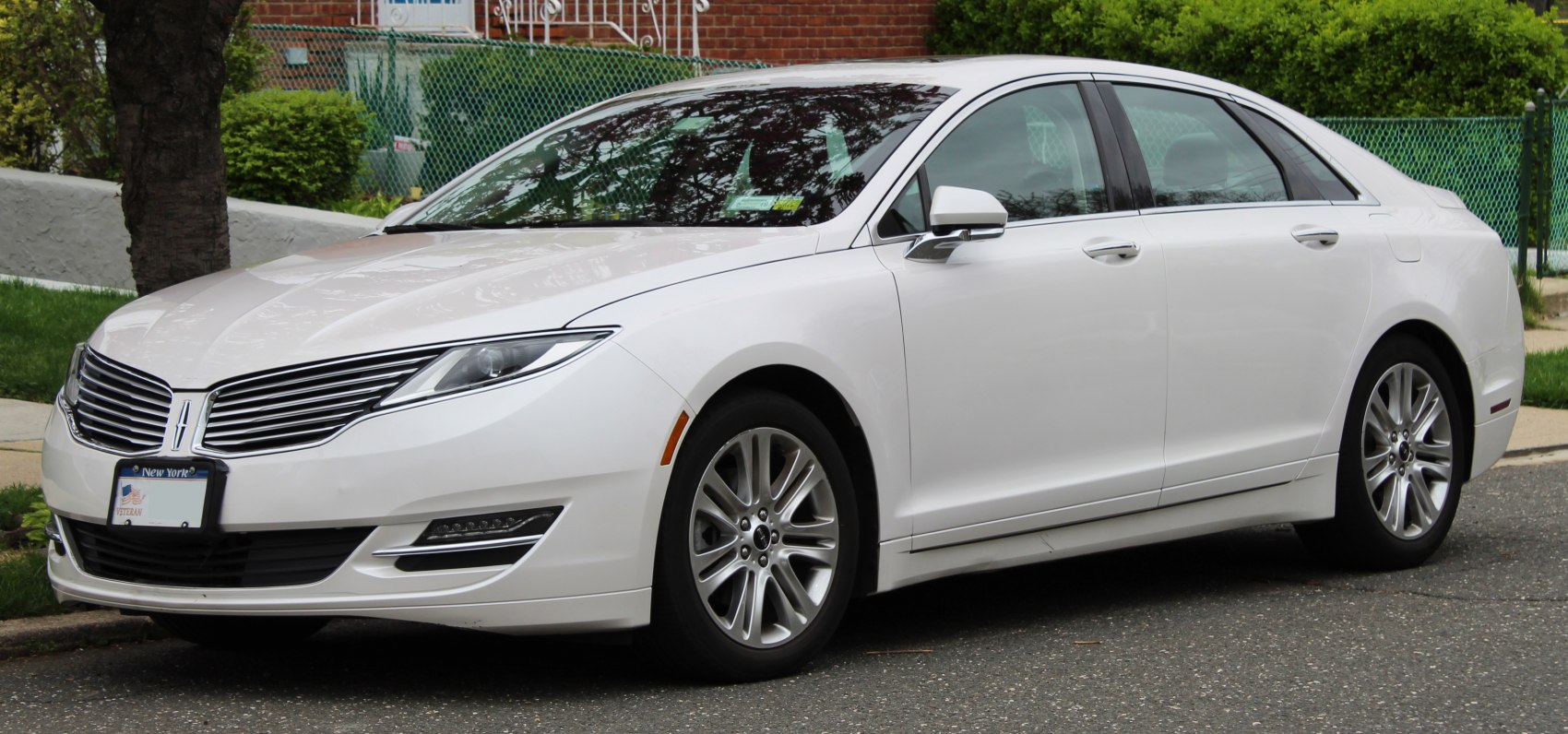 Front side view of luxury sedan with sleek grille and alloy wheels