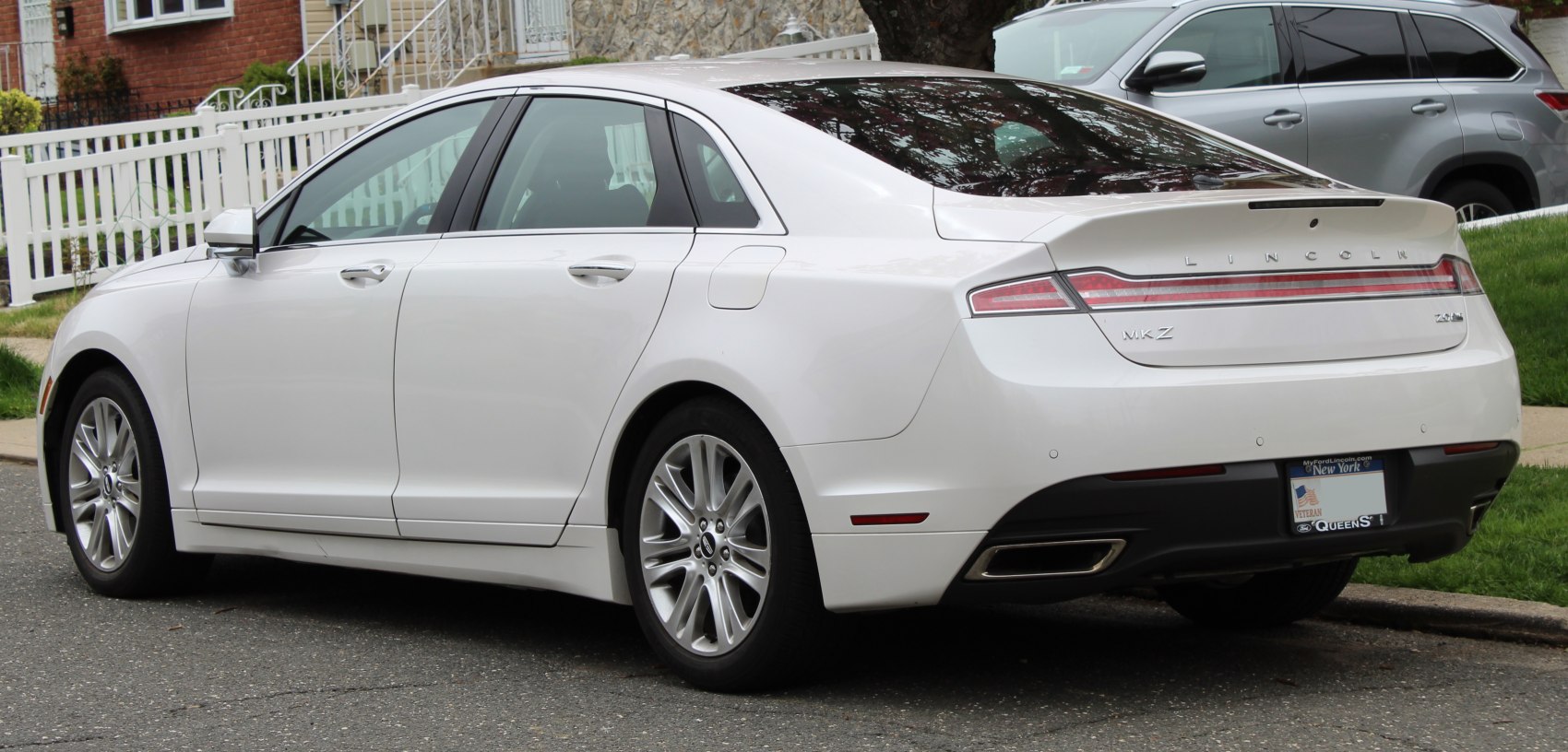 Rear side profile with full-width LED tail light and dual exhaust tips
