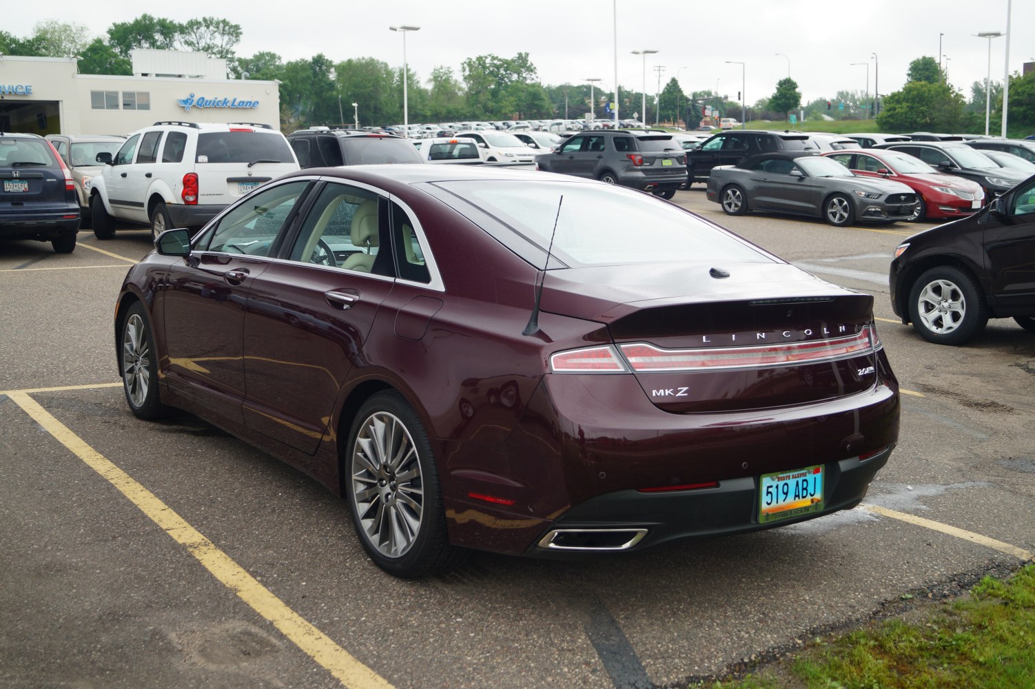 Rear view of sleek sedan with LED tail lights and dual exhaust outlets
