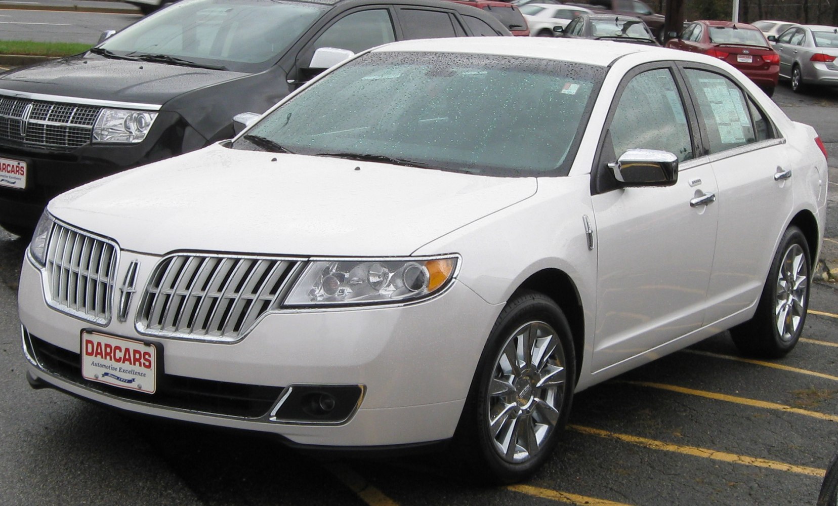 Sedan with vertical chrome grille and shiny alloy wheels.
