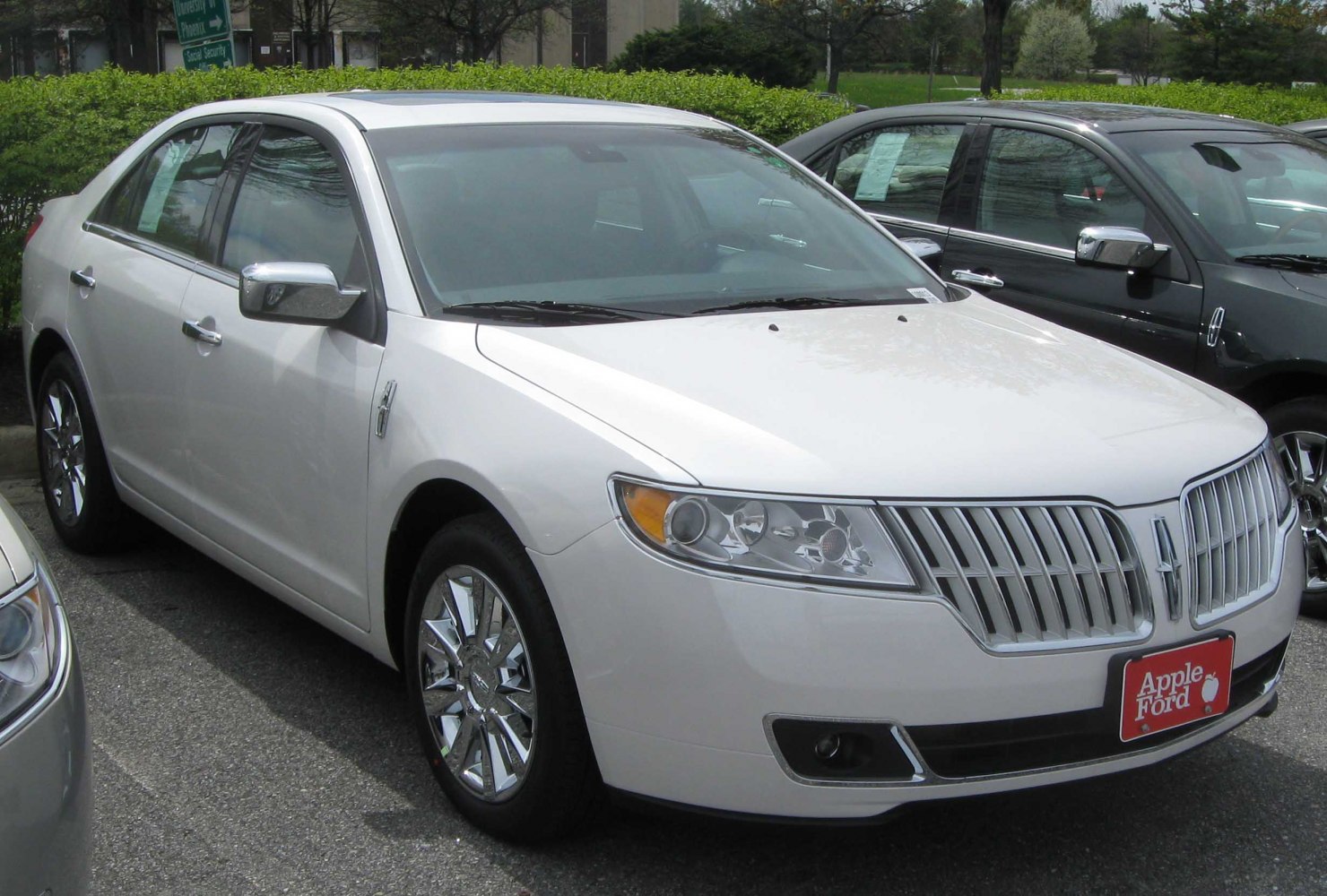 Front and side view of luxury sedan with chrome grille and alloy wheels