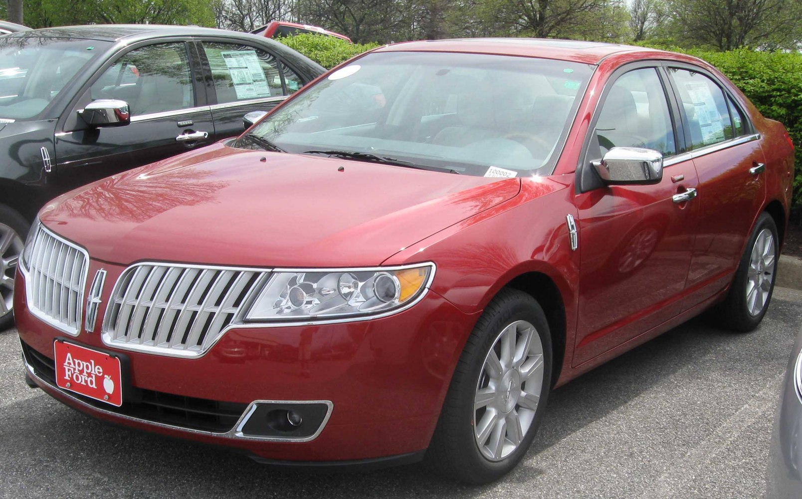 Front view of a sedan with distinctive vertical chrome grille and modern headlights