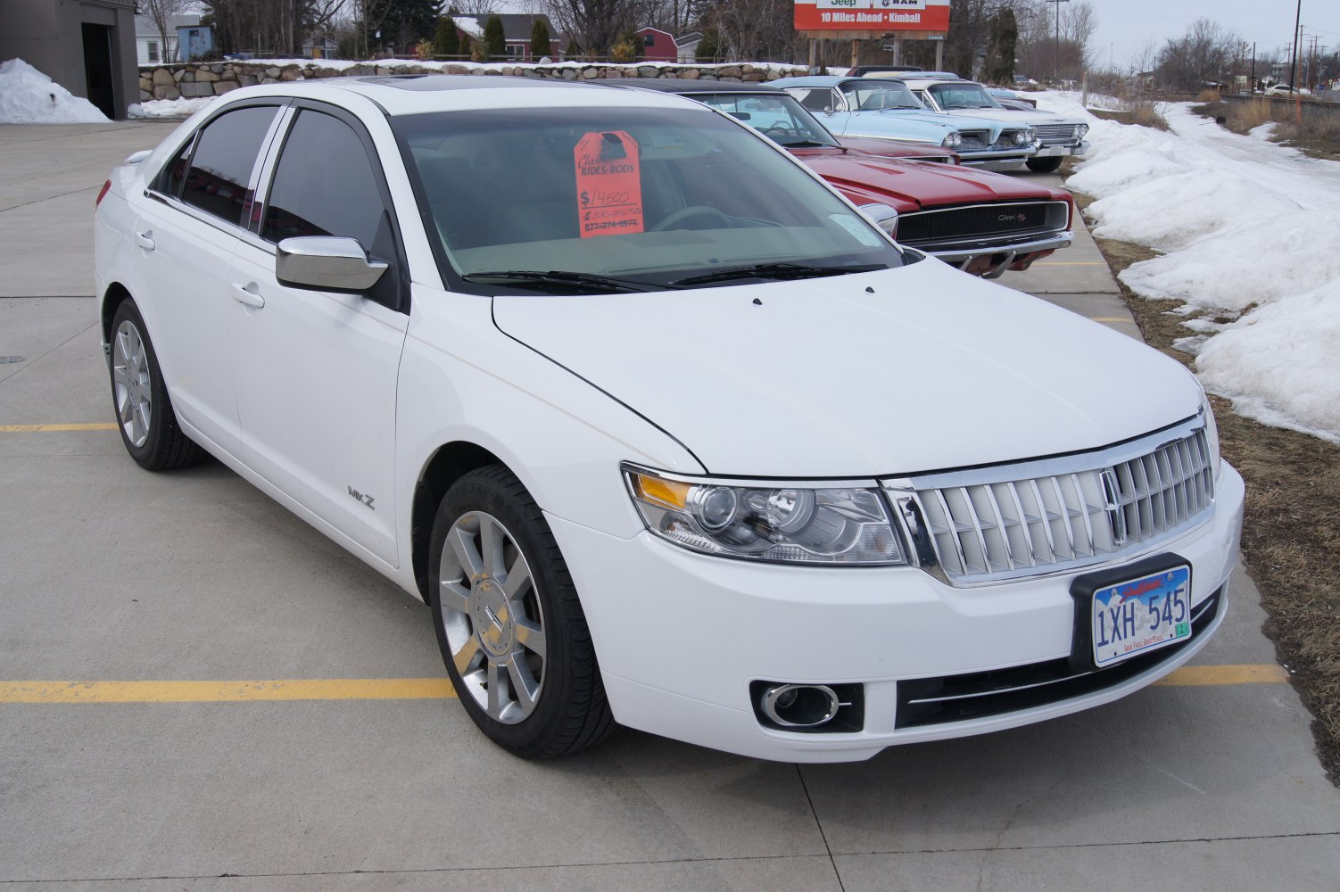 Front-side view with chrome grille and alloy wheels