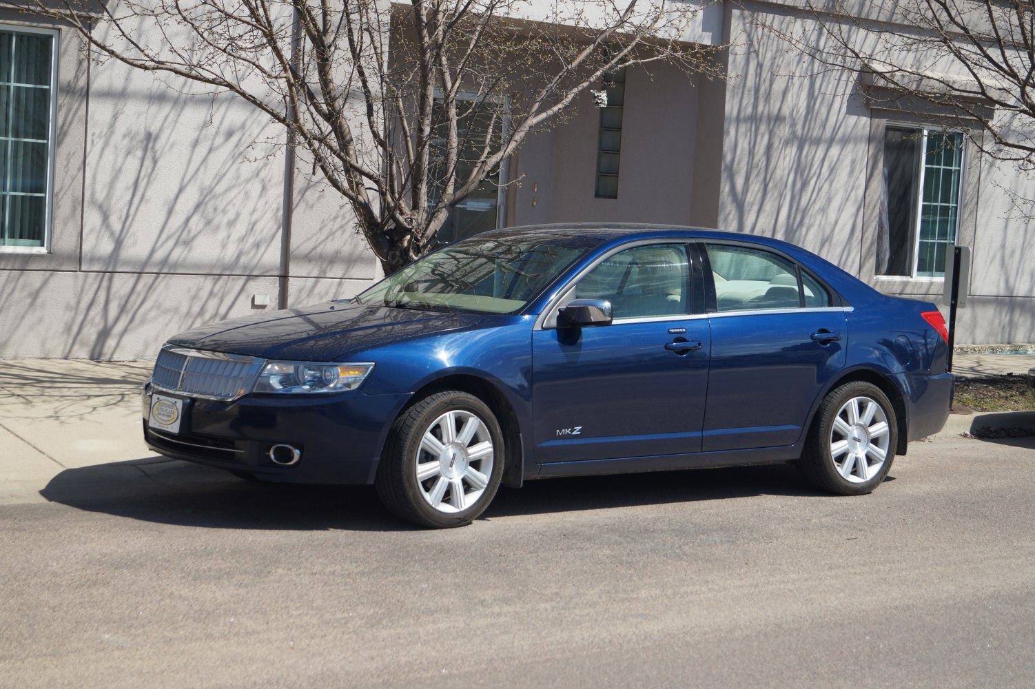 Bold front grille and alloy wheels on a mid-2000s luxury sedan