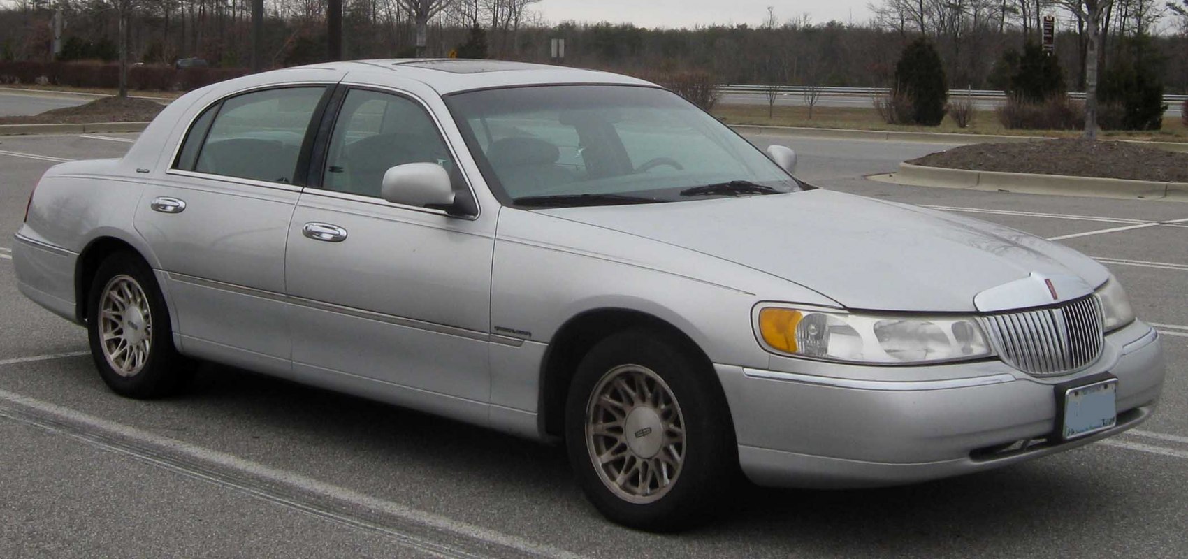 Side-front view of a luxury full-size sedan with chrome grille and distinctive headlights