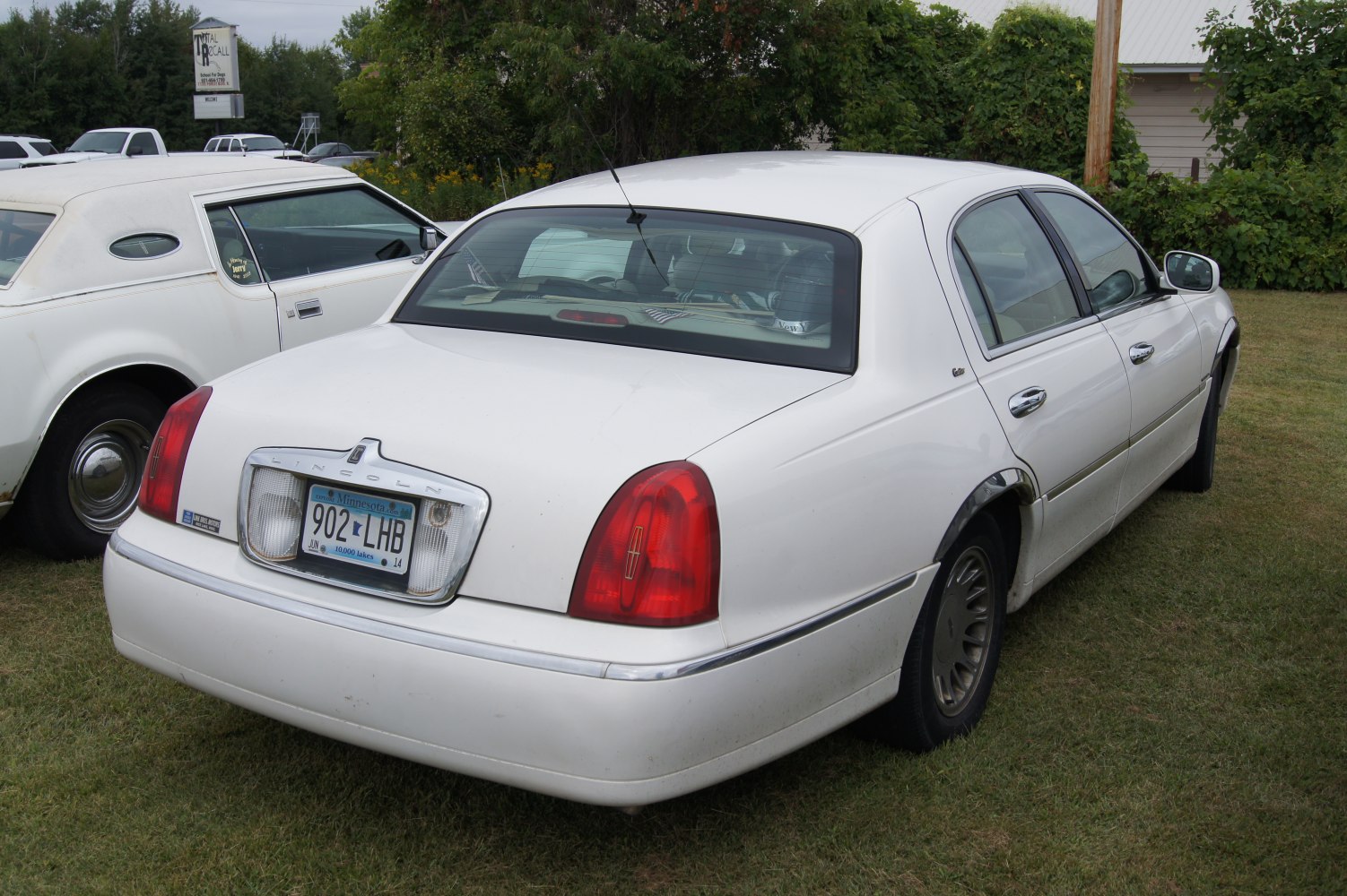 Luxury sedan rear with vertical taillights and chrome trim