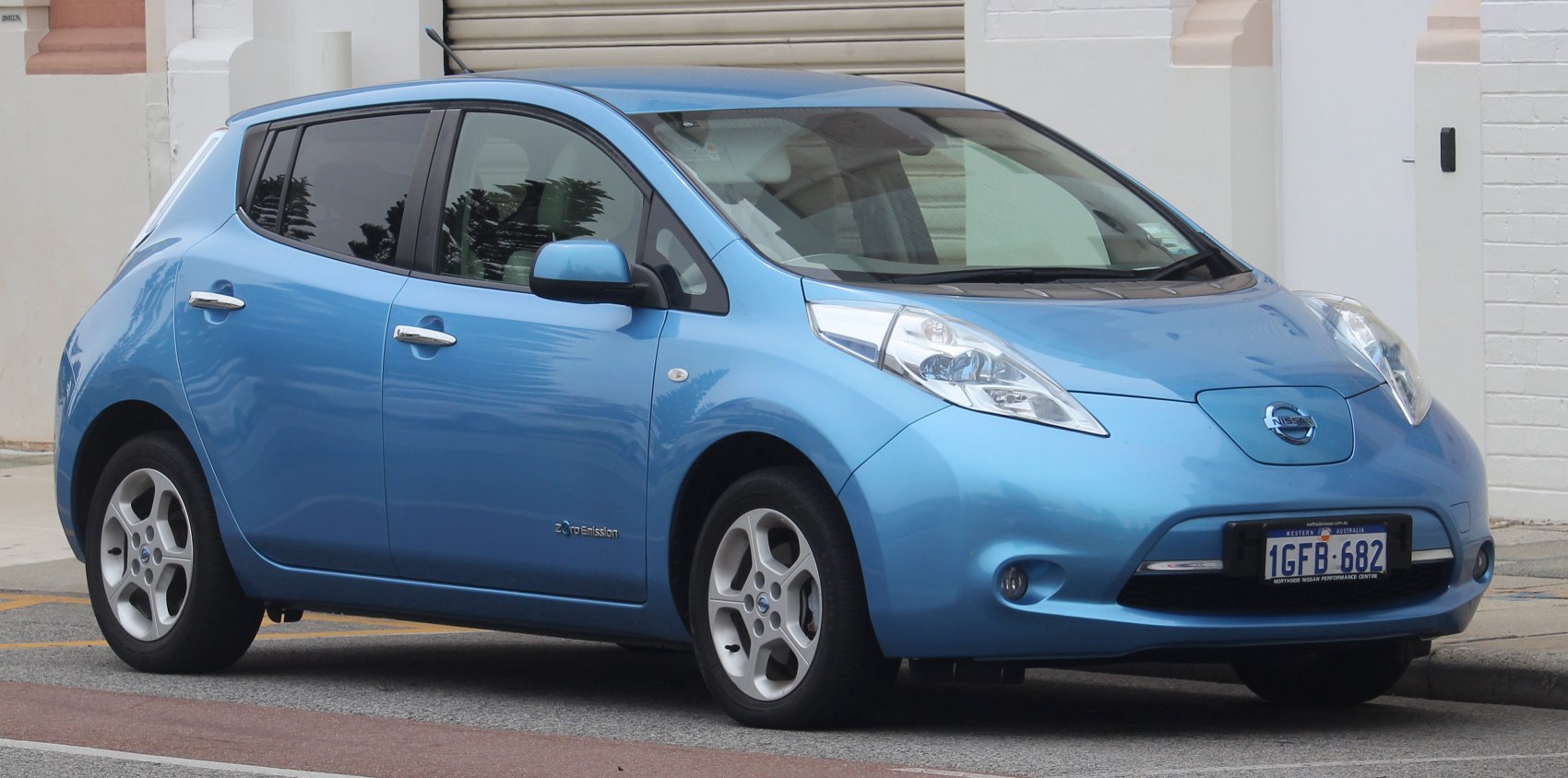 Blue electric hatchback with aerodynamic design and distinctive headlights.