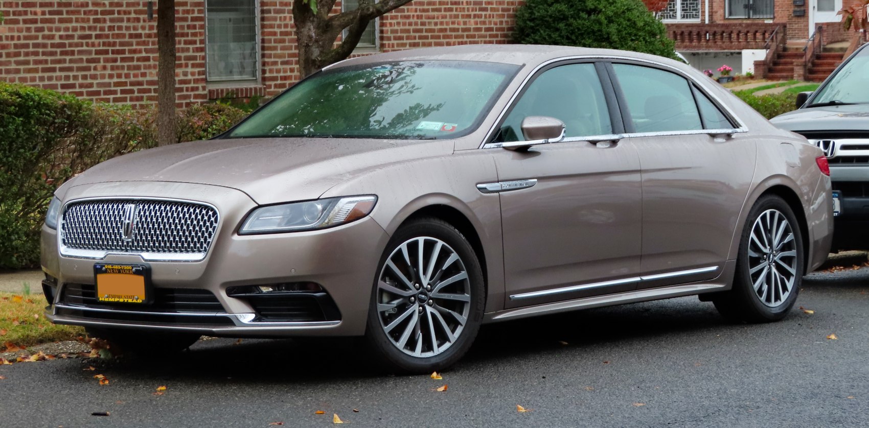 Luxury sedan front-side profile with grille and alloy wheels