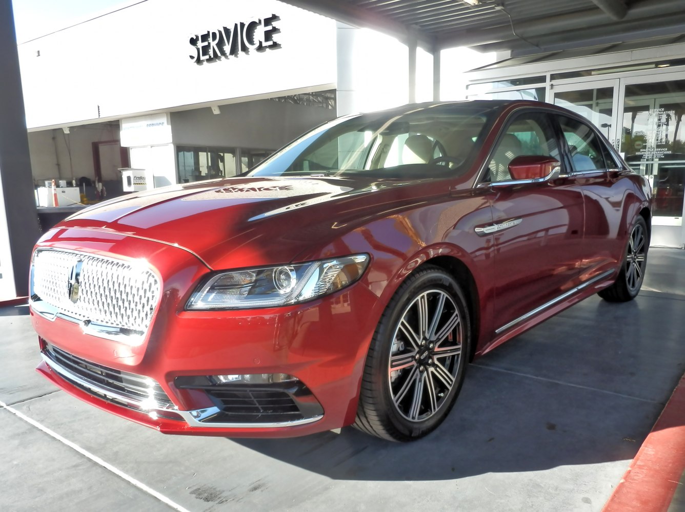 Front view of a luxury sedan with prominent grille and alloy wheels