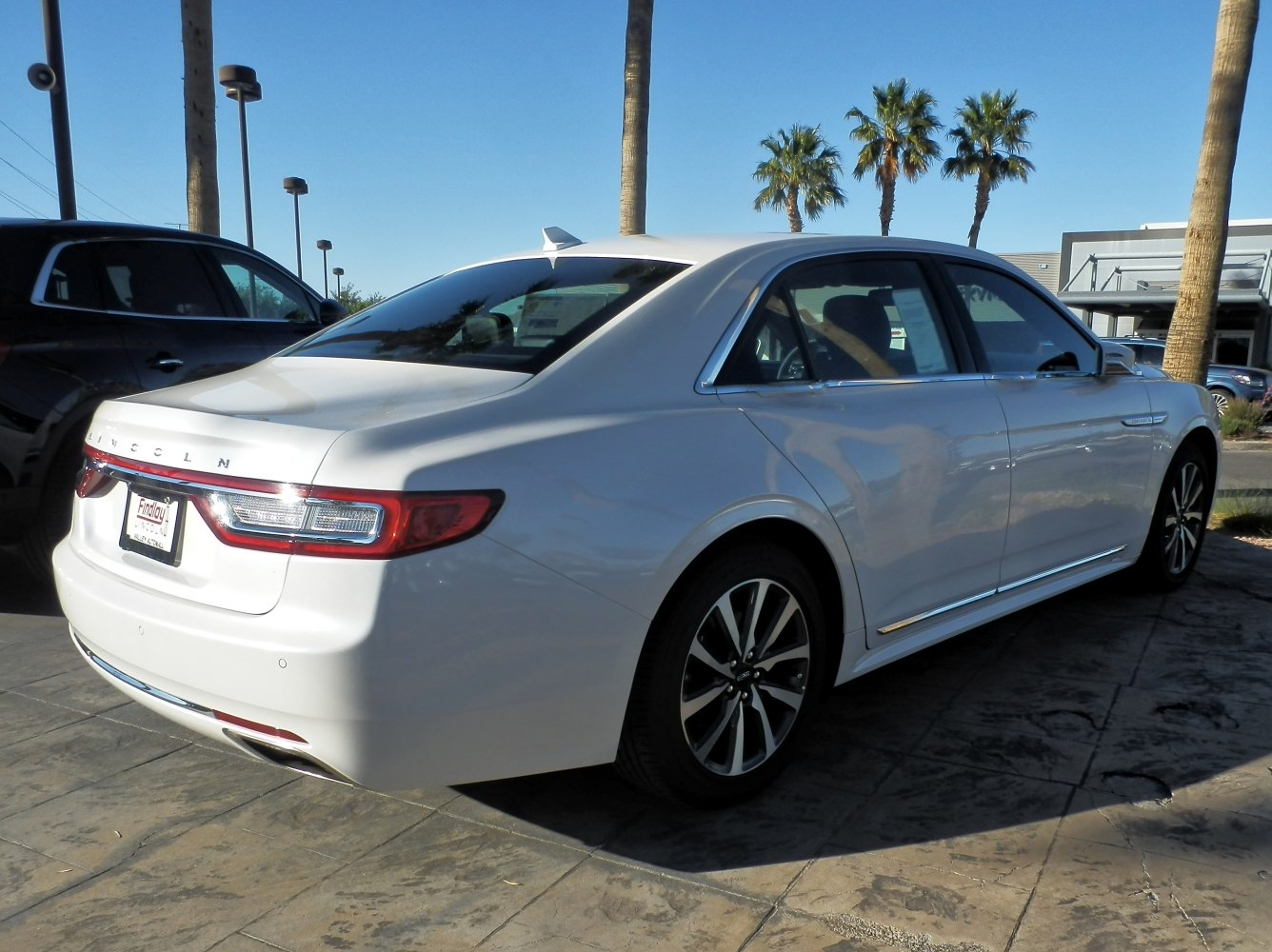 Rear and side profile of a luxury sedan with distinct taillights and alloy wheels