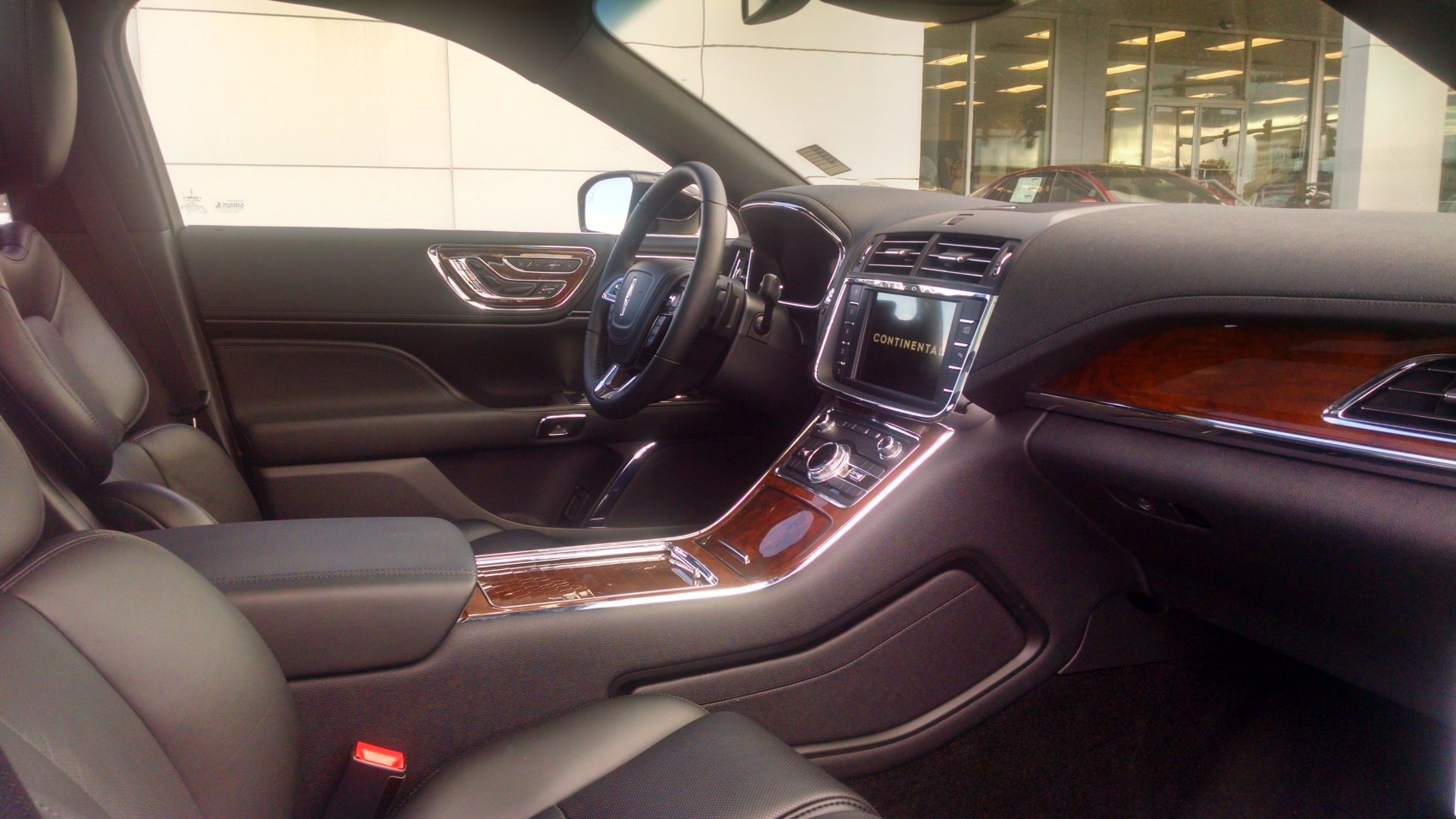 Luxury interior with wood paneling, digital display, modern controls