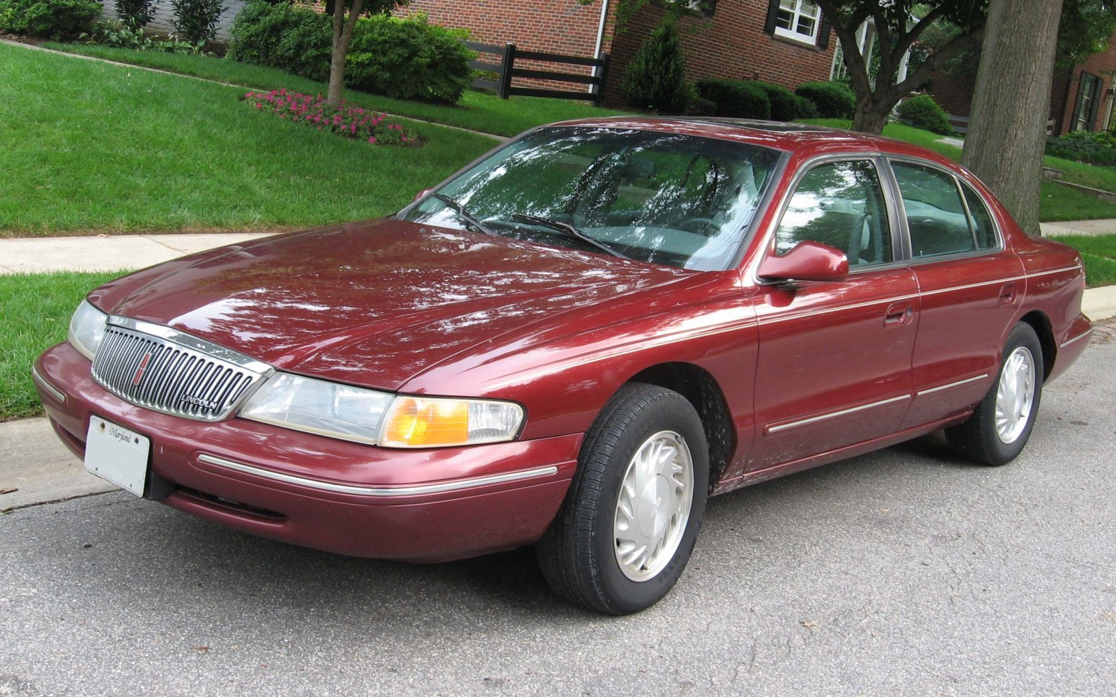 Luxury sedan with vertical-bar grille and wraparound headlights