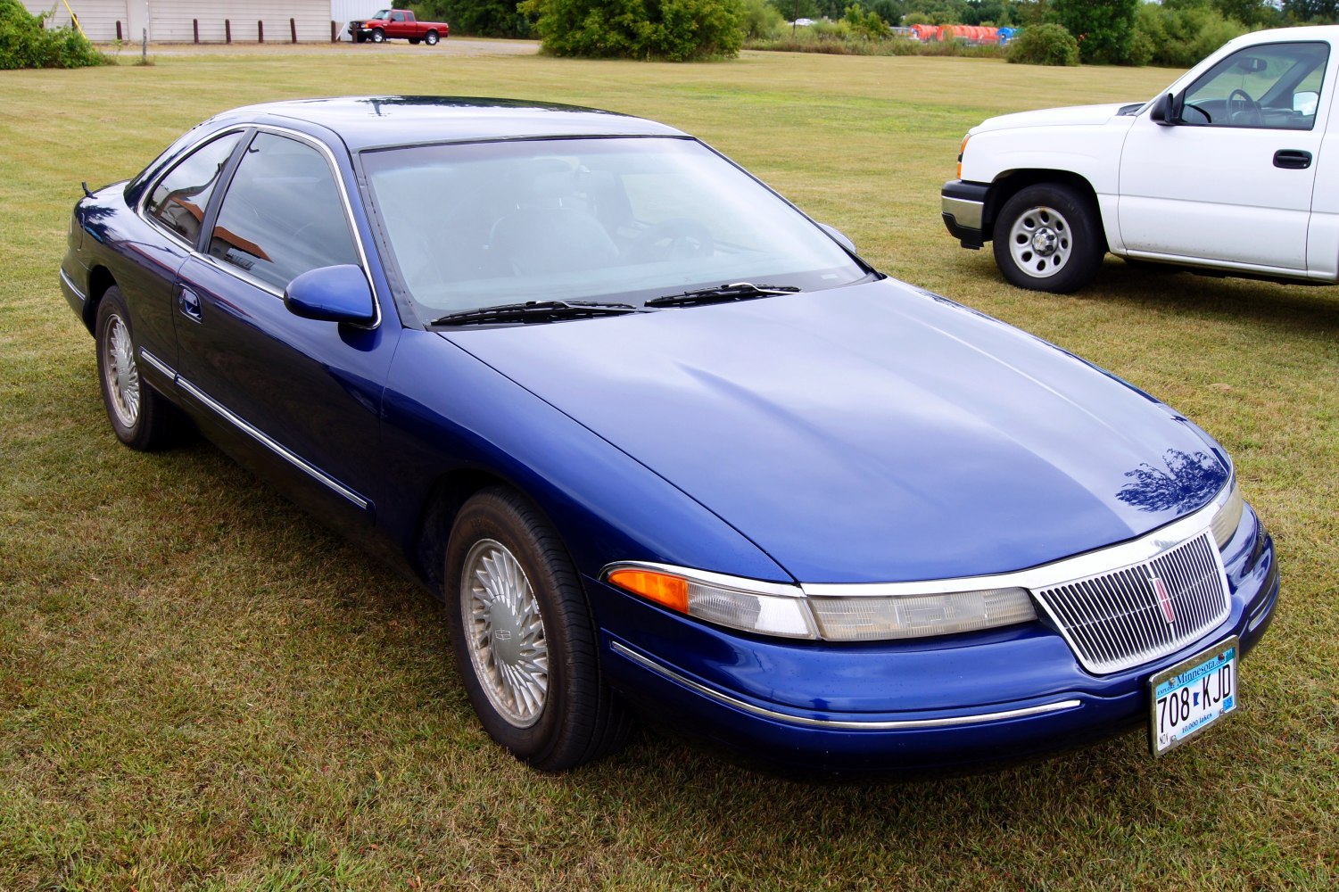 Sleek coupe with distinctive wide vertical grille and clear headlamps