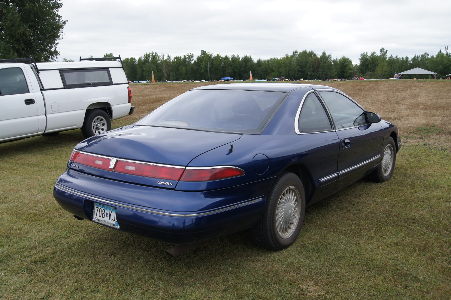 Rear view of a 1993 luxury coupe with distinctive horizontal taillights and smooth body lines.