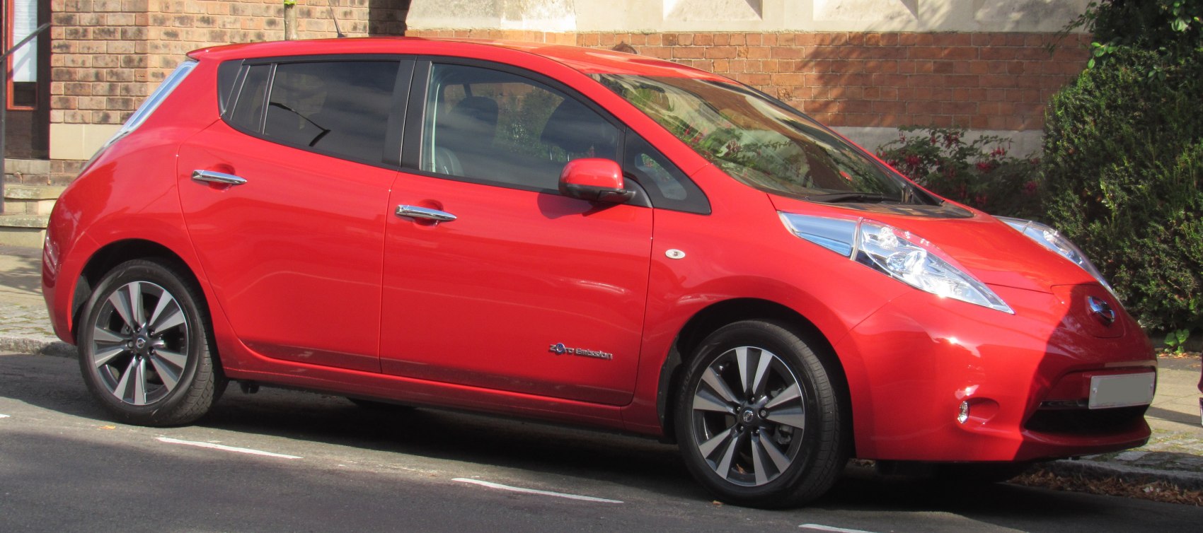Red electric hatchback side profile with alloy wheels