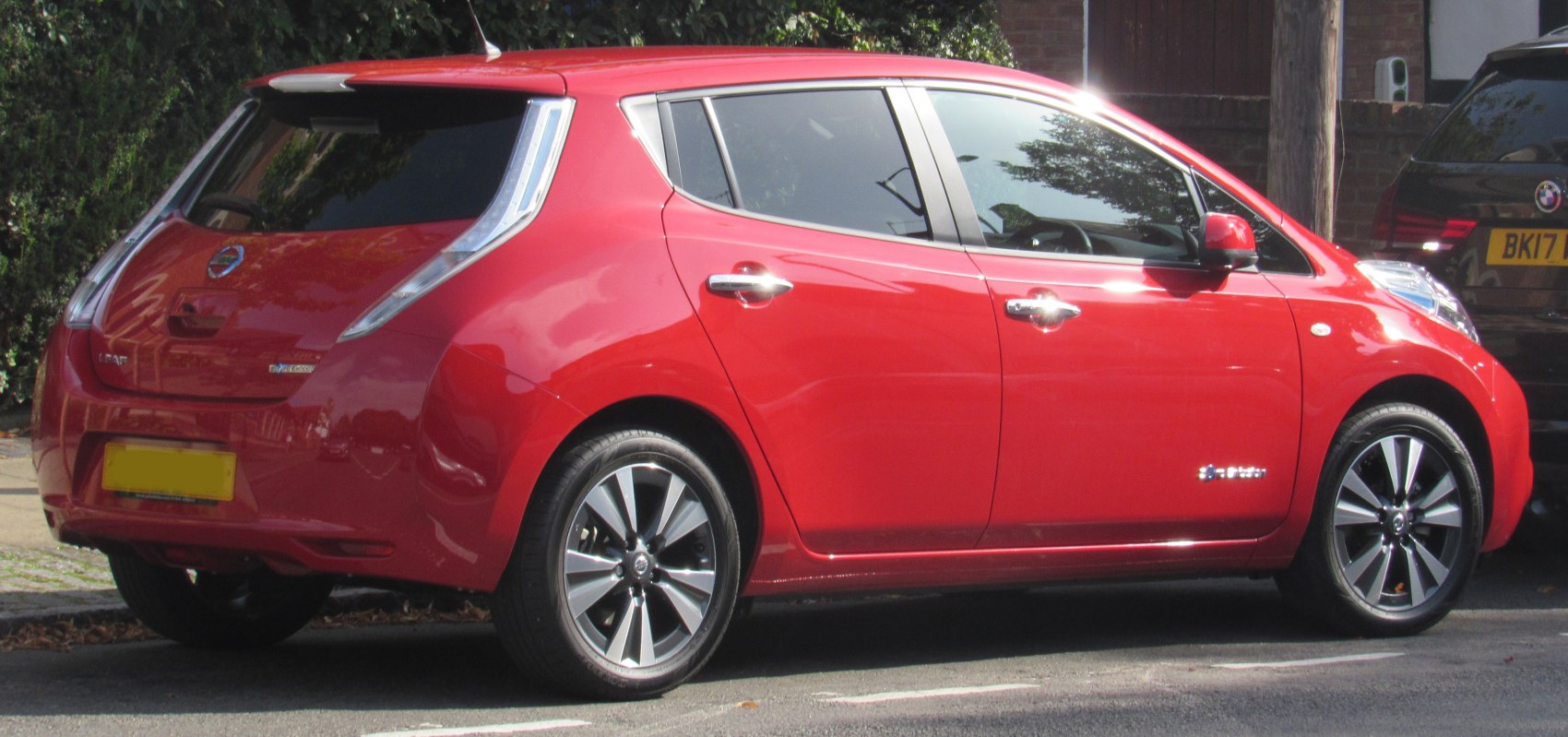 Rear side view of red electric hatchback with aerodynamic rear design