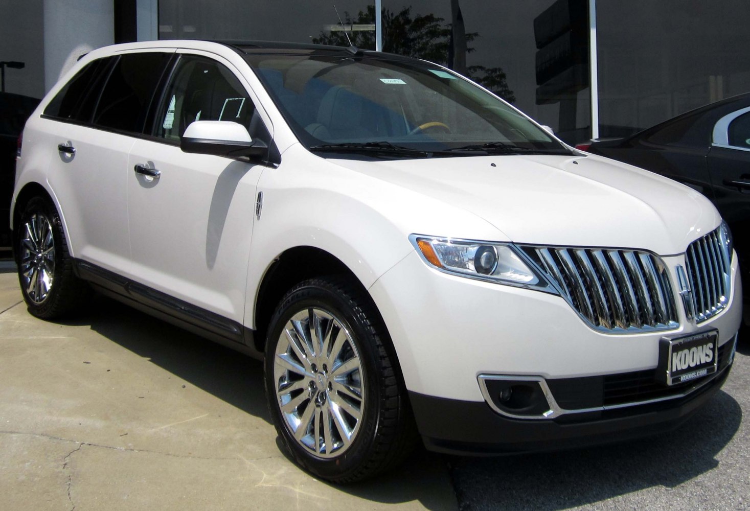 Luxury SUV front-side view with chrome grille and alloy wheels