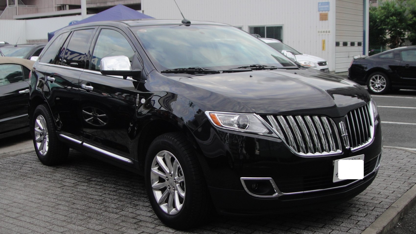 SUV with chrome vertical slat grille and sleek headlights