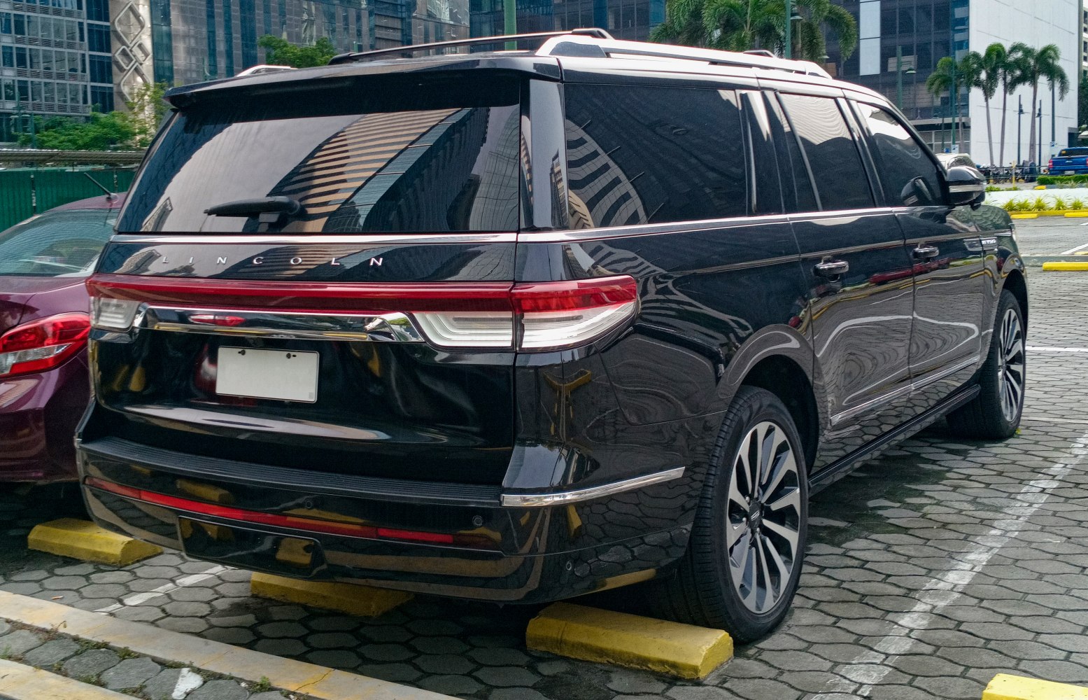 Luxury SUV rear view with LED tail lamps and alloy wheels.