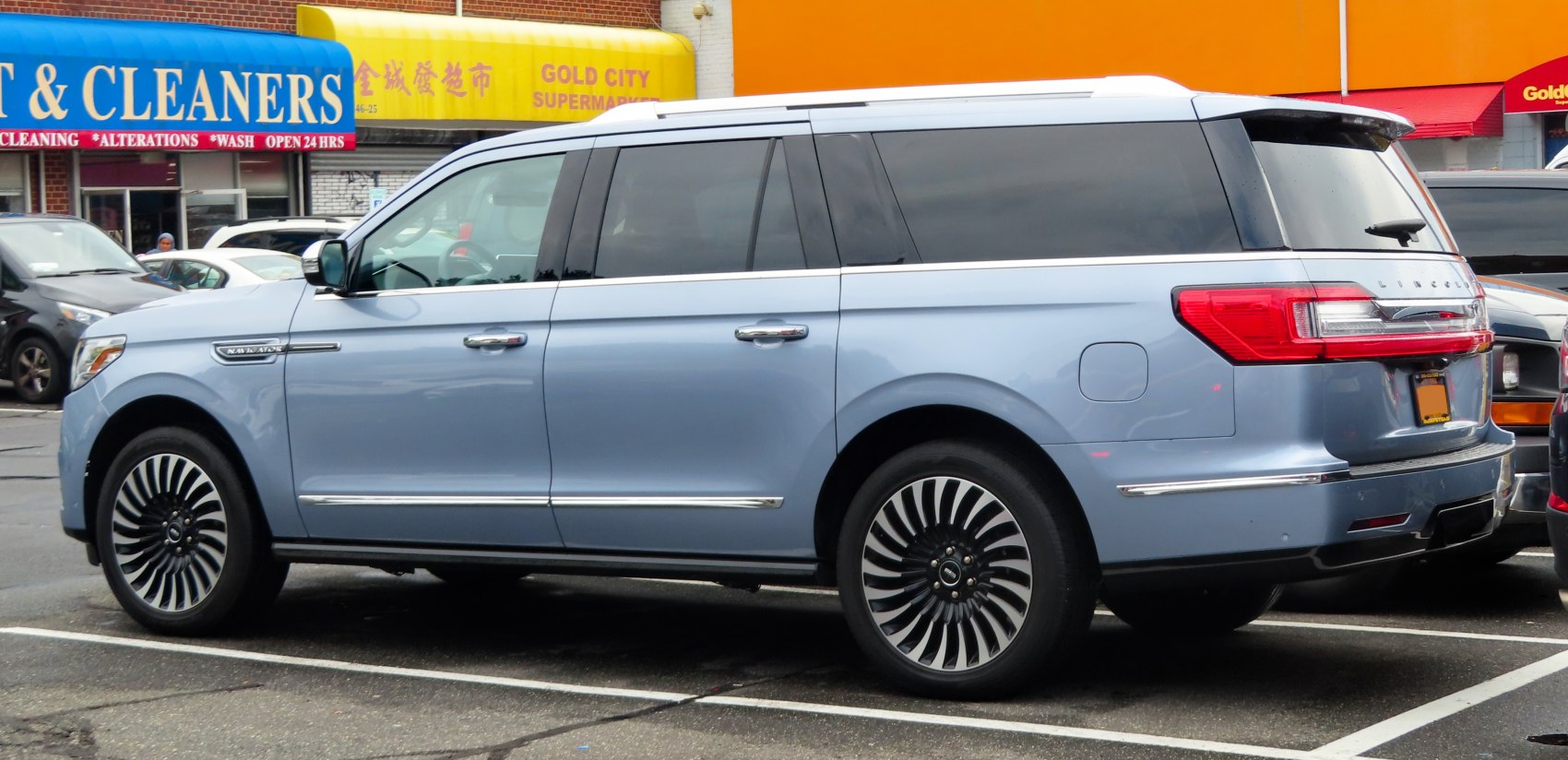 Luxury extended SUV with prominent alloy wheels and sleek rear side profile