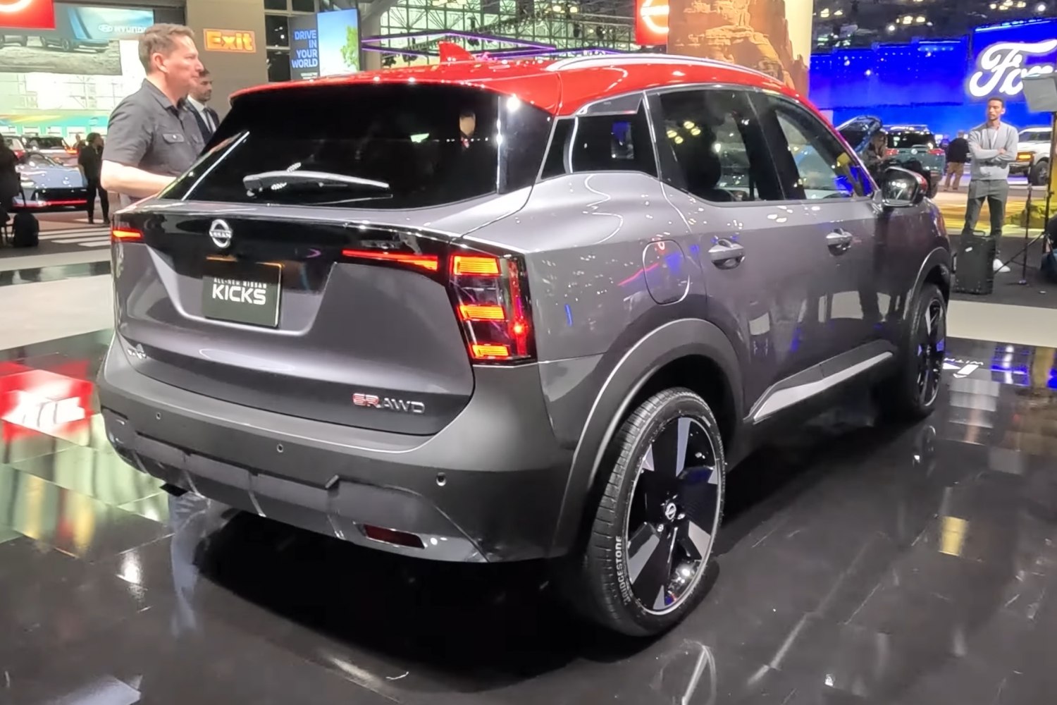 Rear view with LED taillights, AWD badge, and two-tone red and grey exterior.