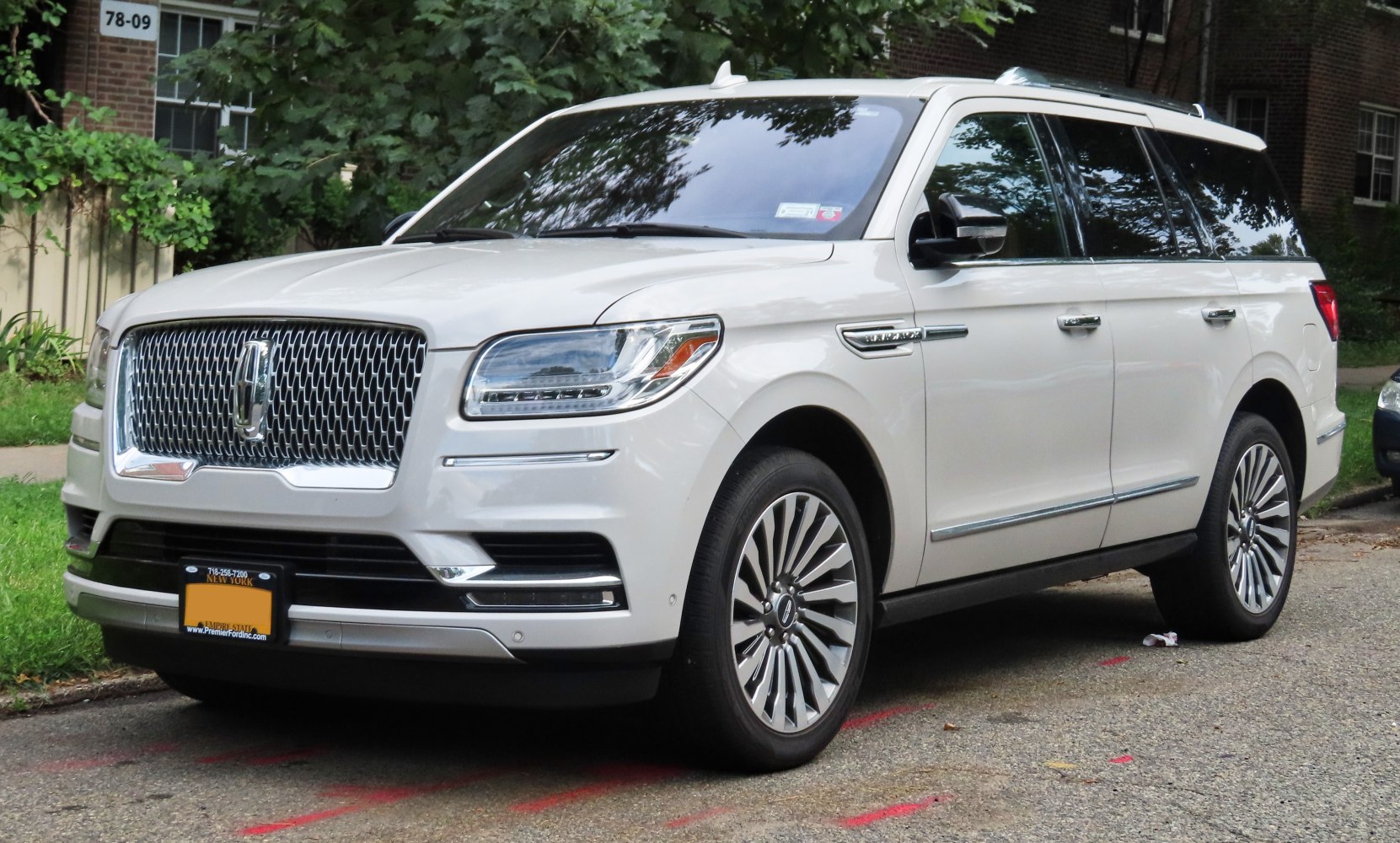 Luxury full-size SUV with prominent chrome mesh grille and LED headlights