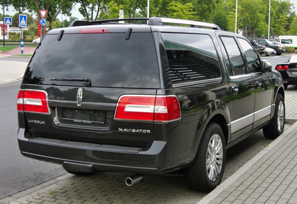 Rear view of luxury full-size SUV with tinted windows and red taillights