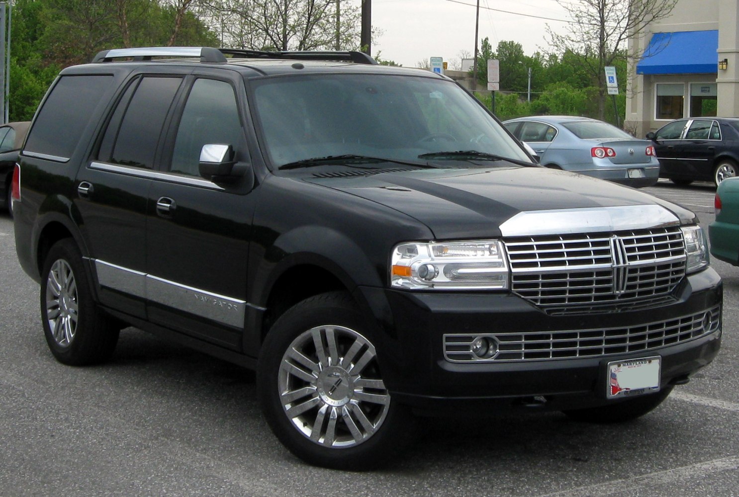 Front and side view of a black SUV with chrome grille and alloy wheels