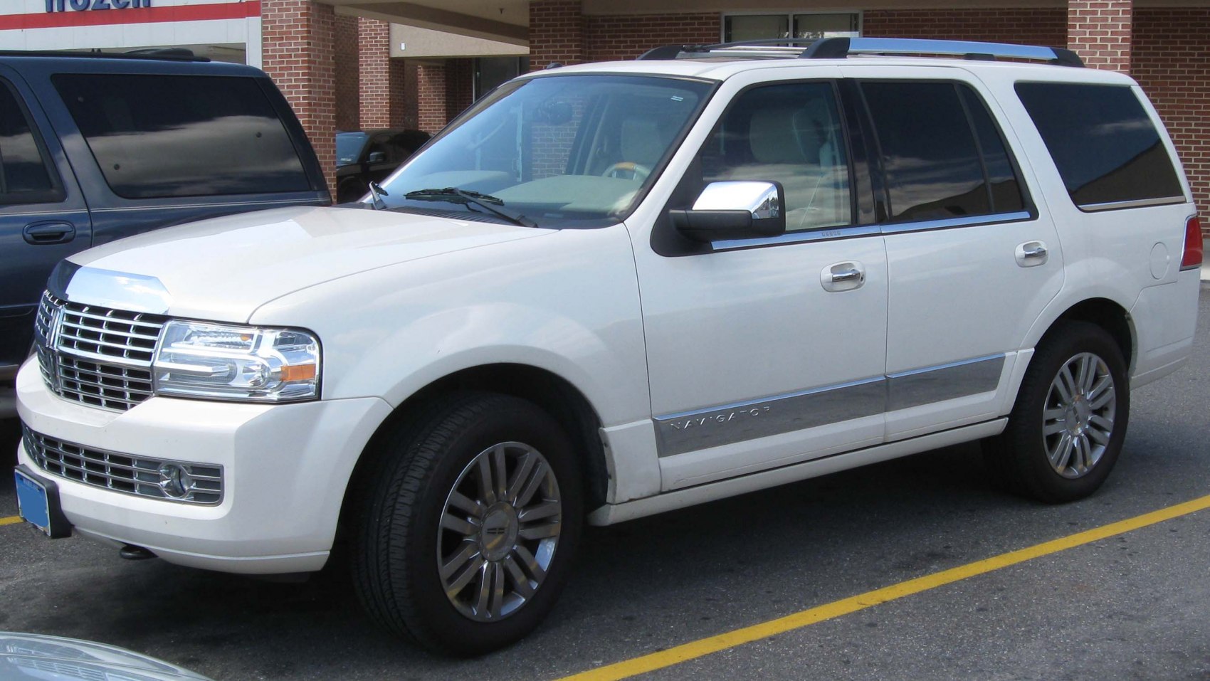 White luxury SUV front and side profile with detailed grille and polished wheels