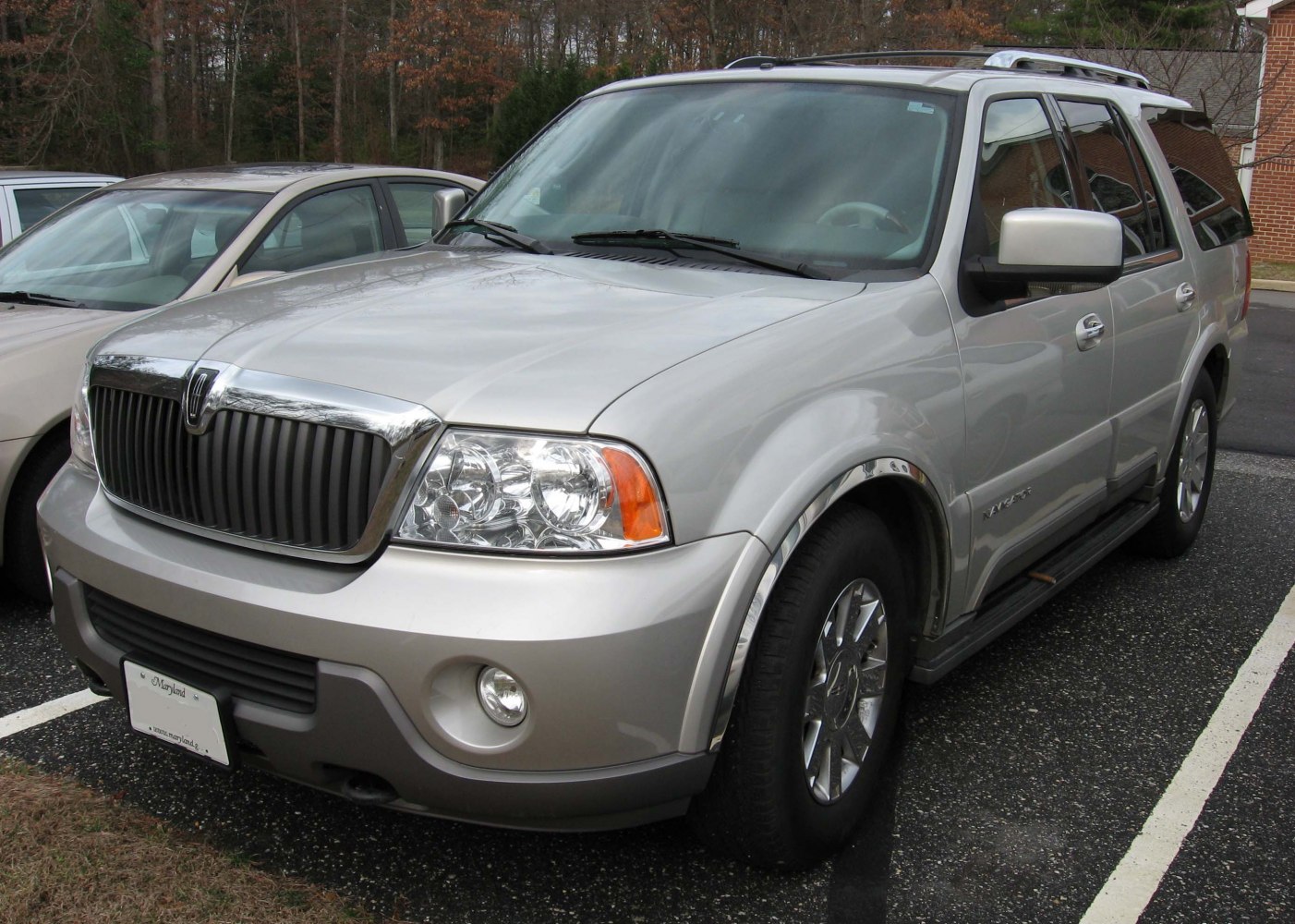 Front view of SUV with chrome grille, fog lights, and alloy wheels