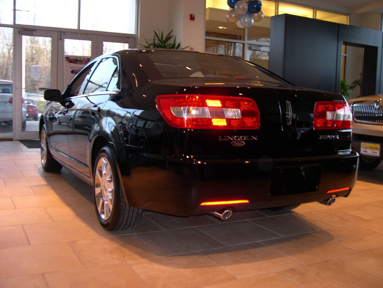 Rear view of sedan with LED tail lights and dual exhaust