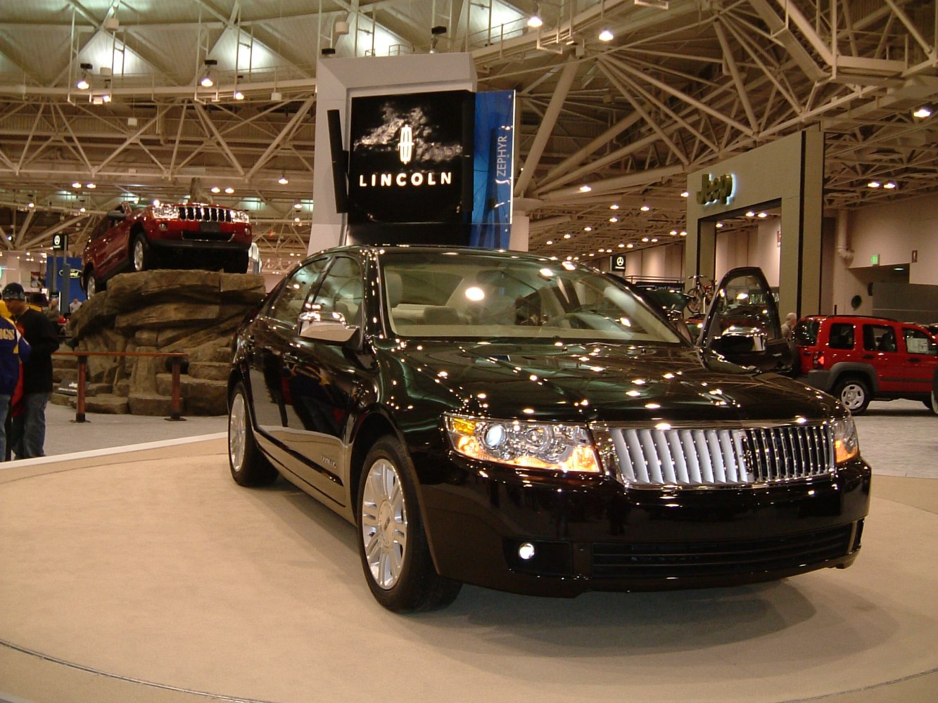 Front view of a luxury sedan with chrome vertical grille and prominent headlights