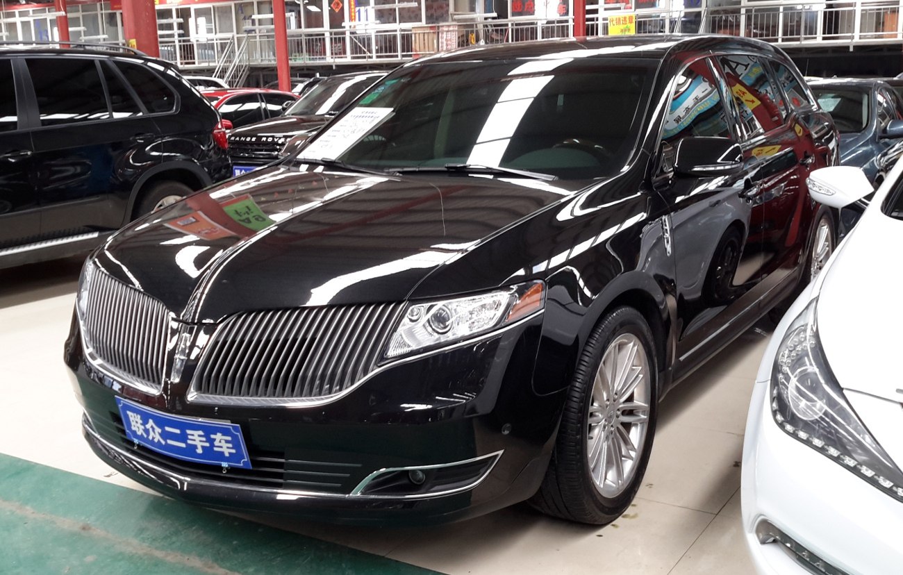 Front view with chrome vertical grille and sleek headlights