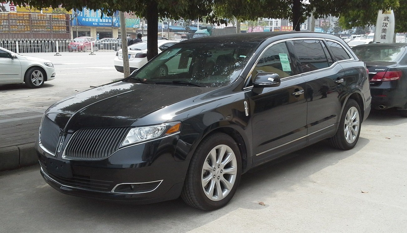 Luxury SUV with vertical grille and multi-spoke alloy wheels