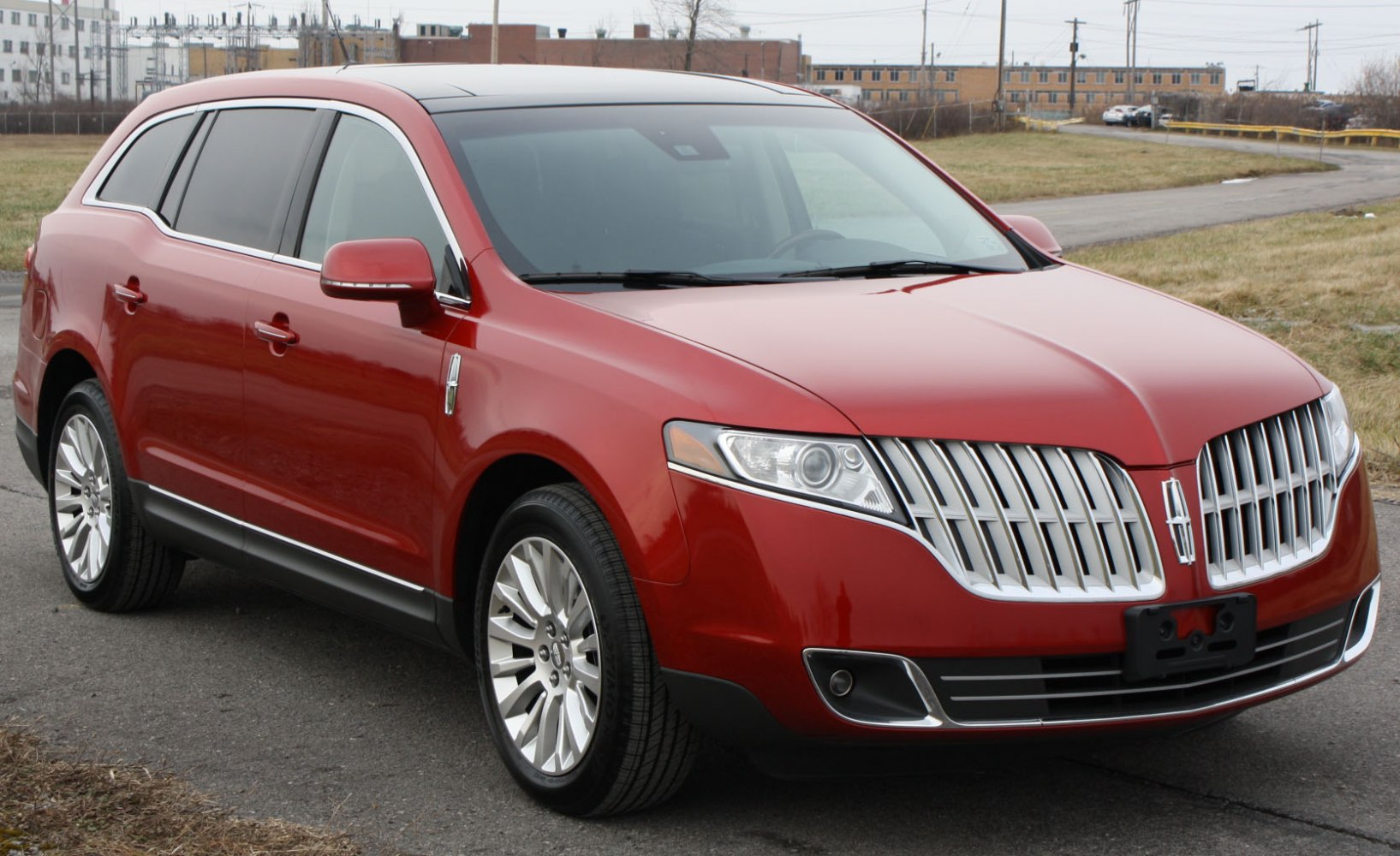 Front side view featuring vertical grille and sleek headlights