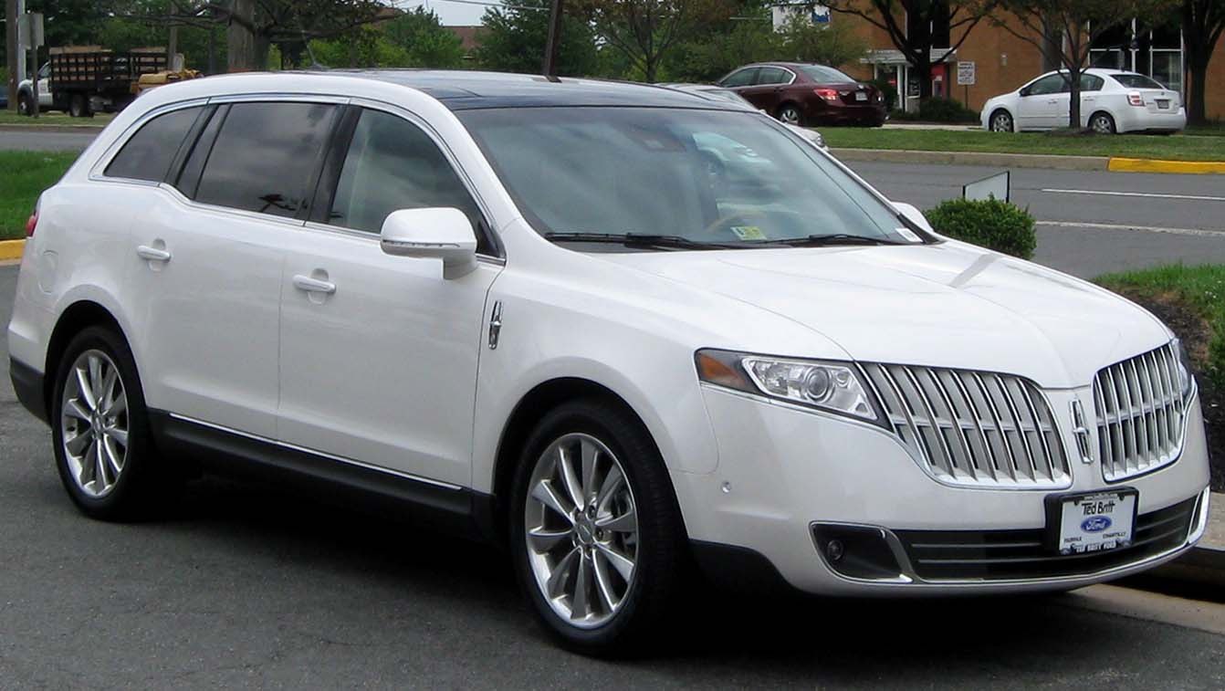 White luxury crossover SUV with chrome grille and alloy wheels