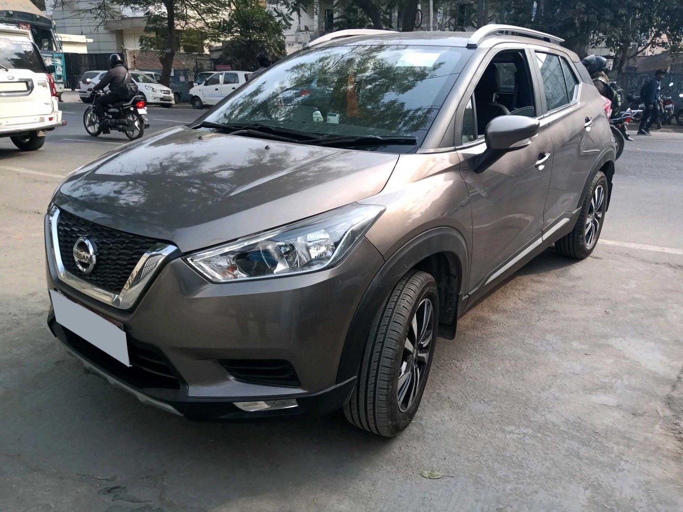 Sharp front angle view with headlights and alloy wheels