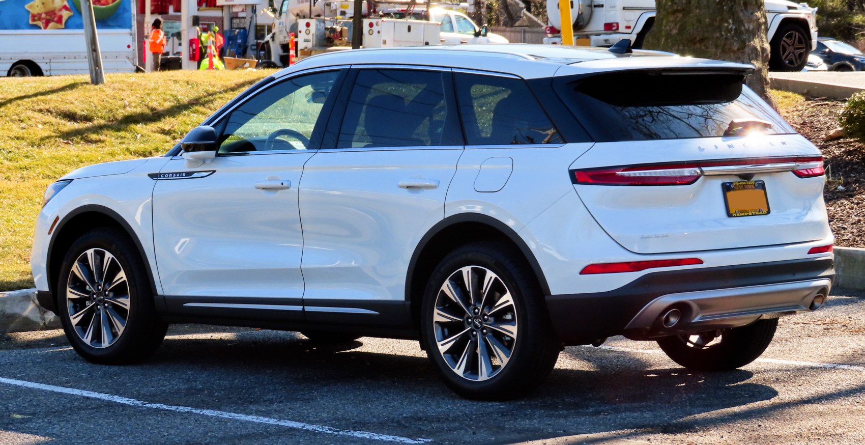 White luxury SUV rear and side view with sleek taillights and modern wheels.