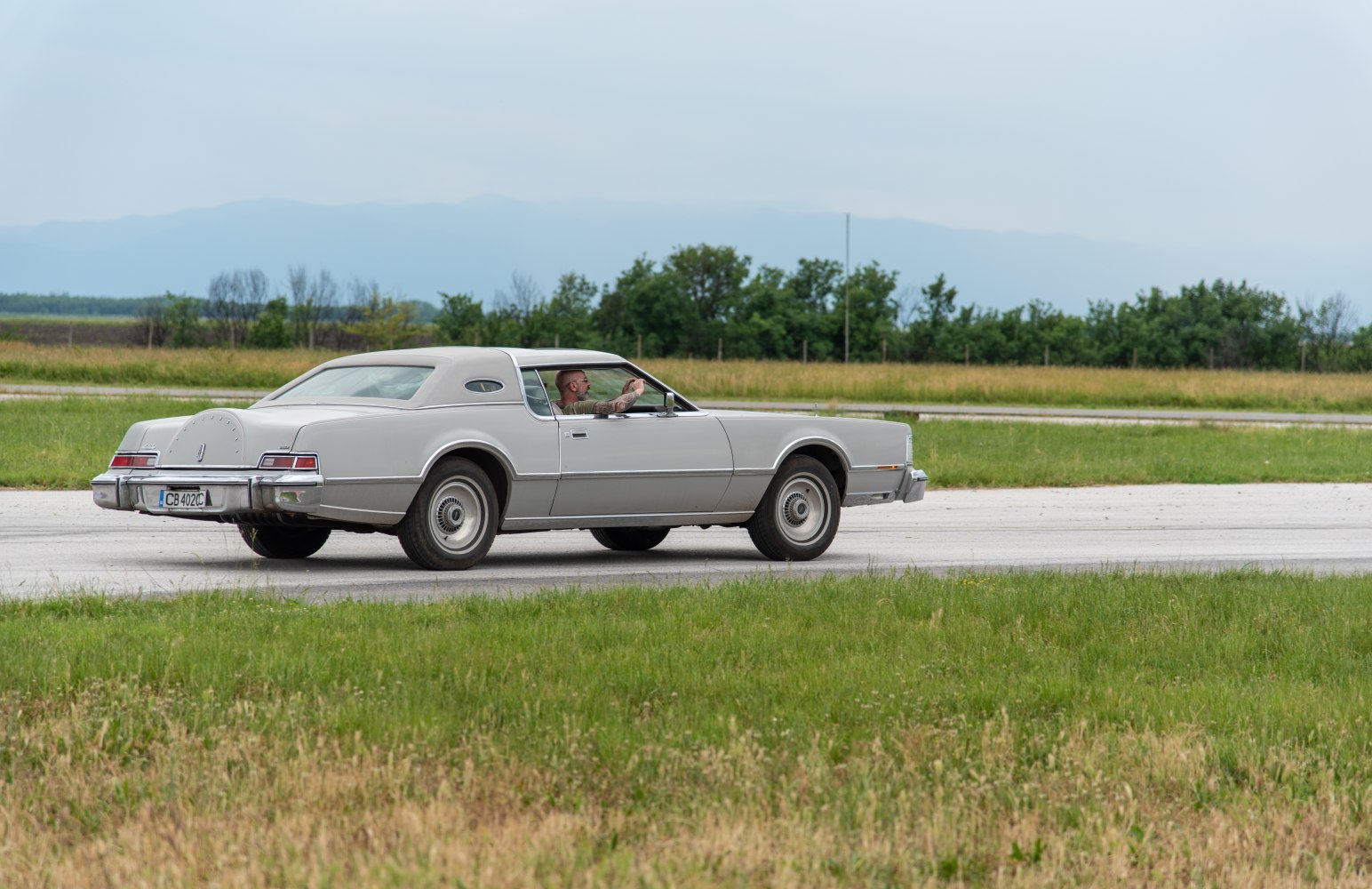 Classic vintage coupe with rear spare wheel and vintage hubcaps