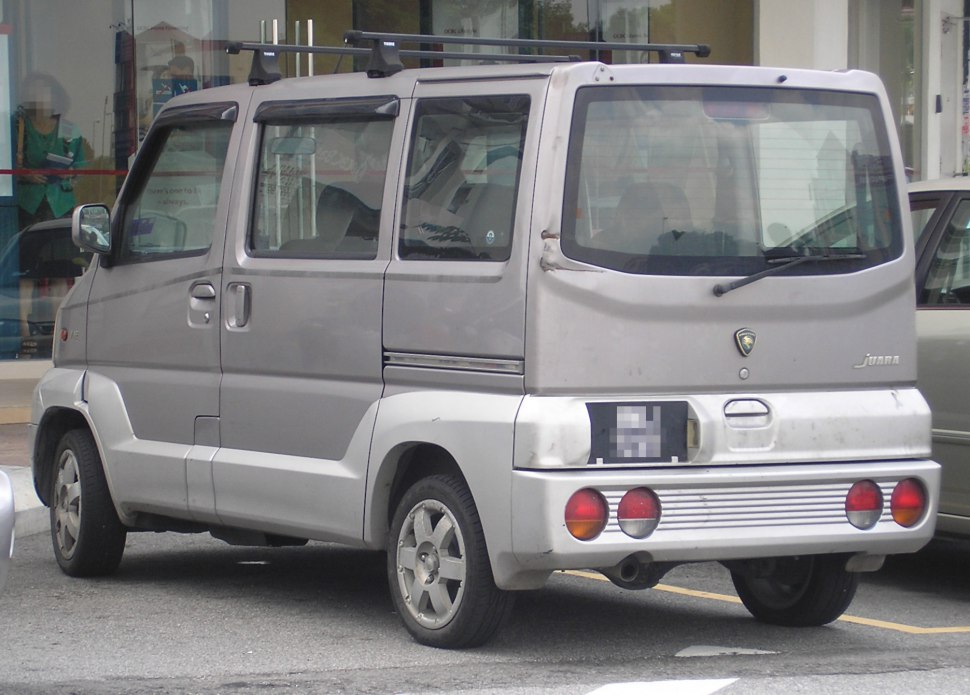 Compact MPV rear view with sliding door and boxy shape.