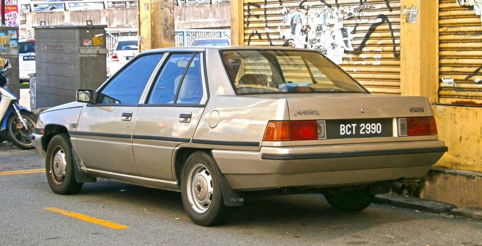 Rear view of a classic 1980s sedan with angular design and vintage taillights.