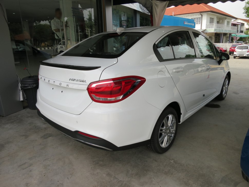 Rear view of white sedan with prominent taillights and modern design