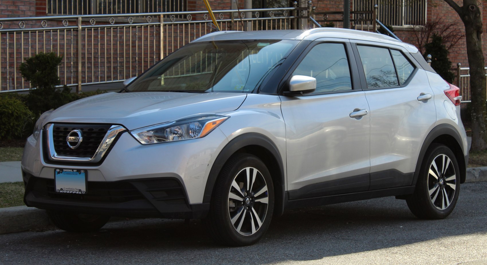 Front side view of silver compact SUV with alloy wheels and distinctive headlights